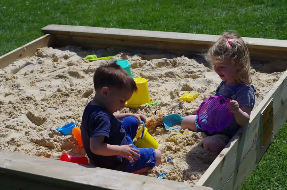 Sandpit with kids playin in it