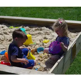 Thumbnail of Sandpit with kids playin in it