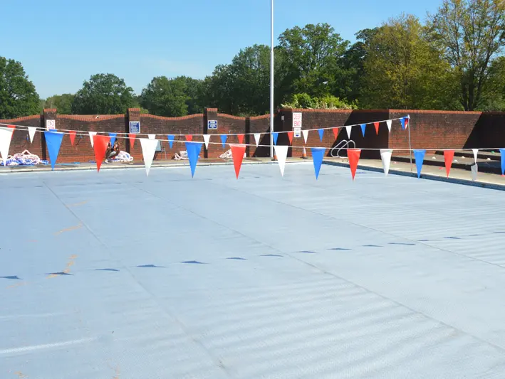 Outdoor swimming pool with a RaeGuard cover